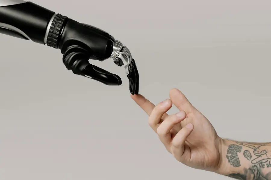 An AI robot hand touching a human hand in symbiosys.