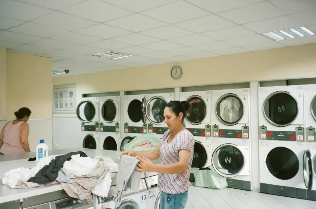 2 ladies working in the laundry department of a hotel