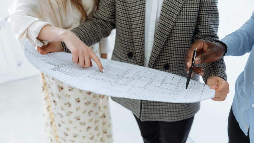 Chefs in a hospitality kitchen preparing food while managing waste and maintaining efficient kitchen operations.