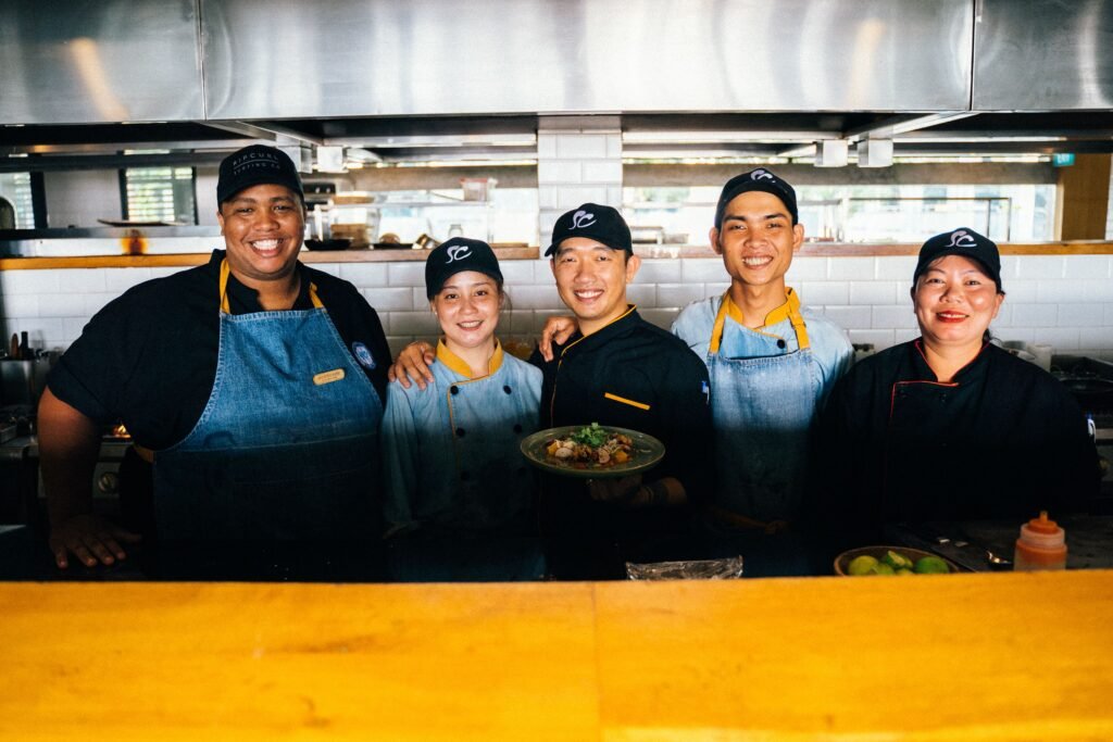 Hospitality consulting-designed kitchen team resetting buffet stations between service periods