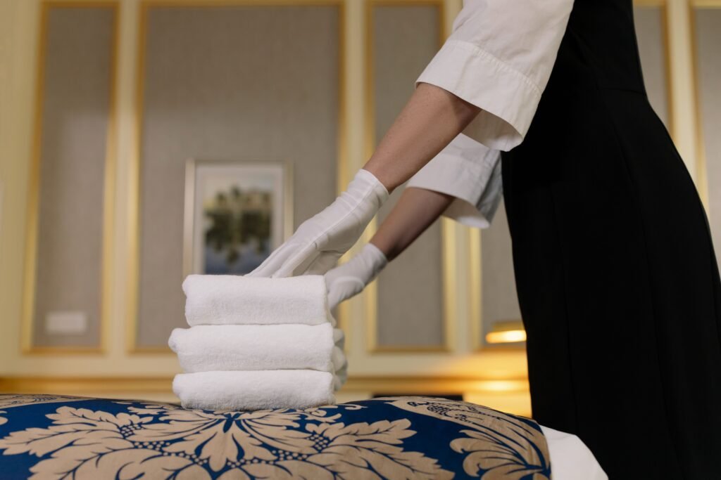 Hotel housekeeping team completing room turnover with freshly laundered linen from a well-planned laundry system