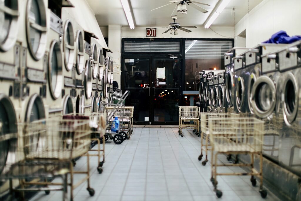 Hotel laundry room in active operation, illustrating hotel laundry design through steam management, space allocation and workflow sequence. Copy image description