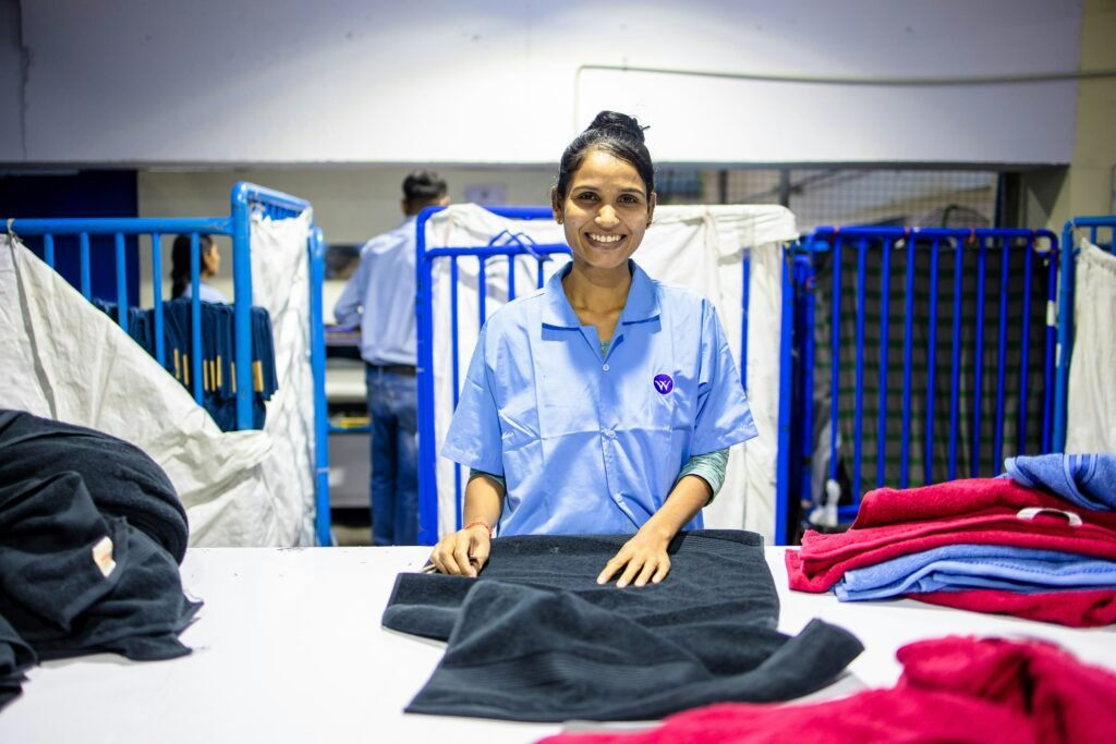 Hotel laundry staff operating efficiently through a well-designed laundry workflow built on sound Laundry Designs and Planning